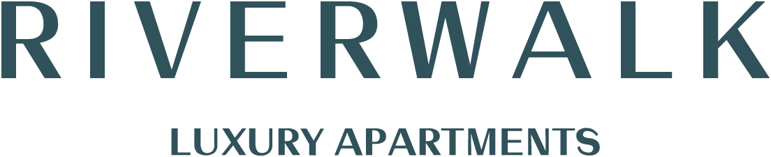A sign for Riverwalk Luxury Apartments.